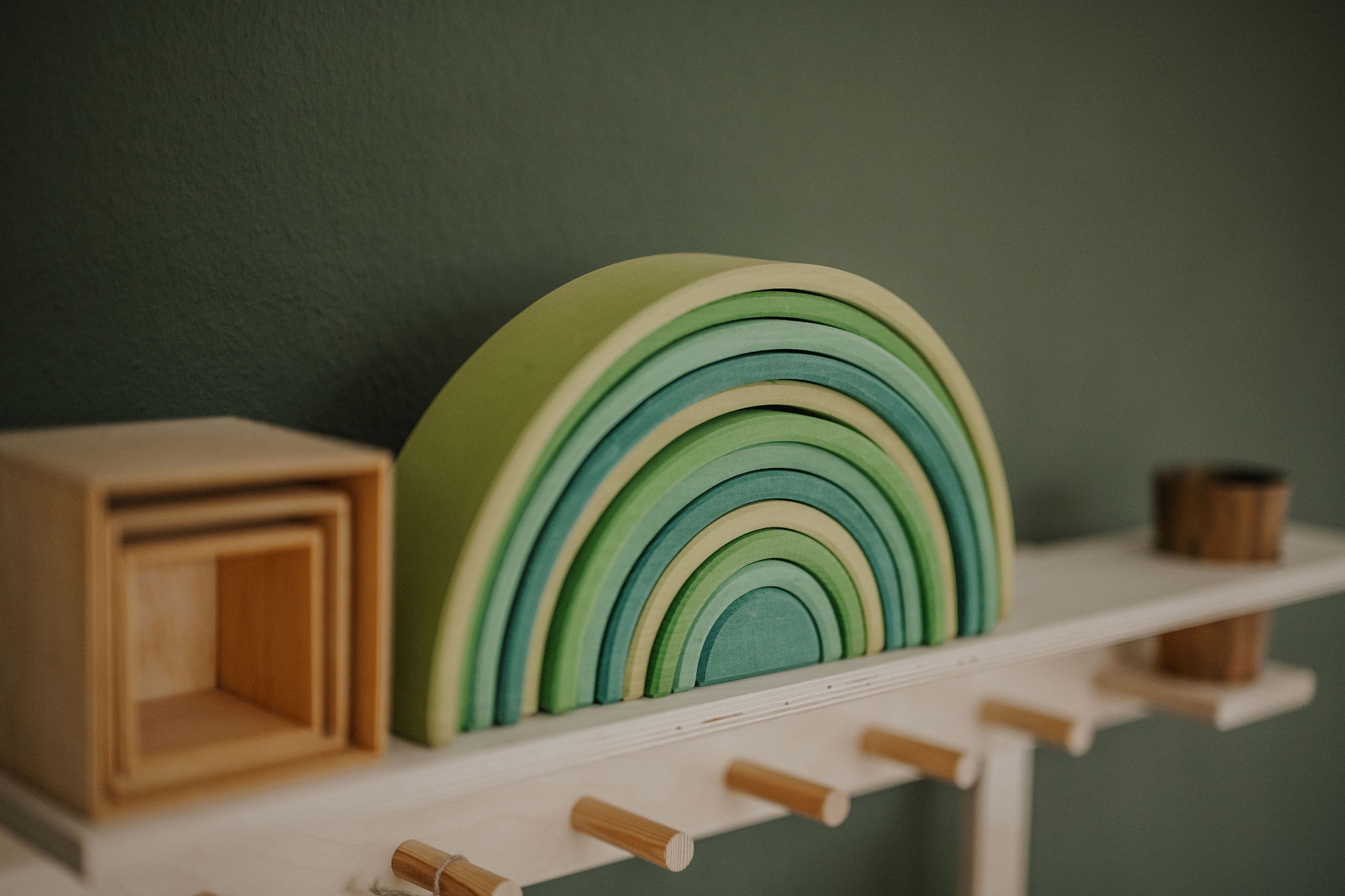 Wooden rainbow stands on a wooden children's kitchen