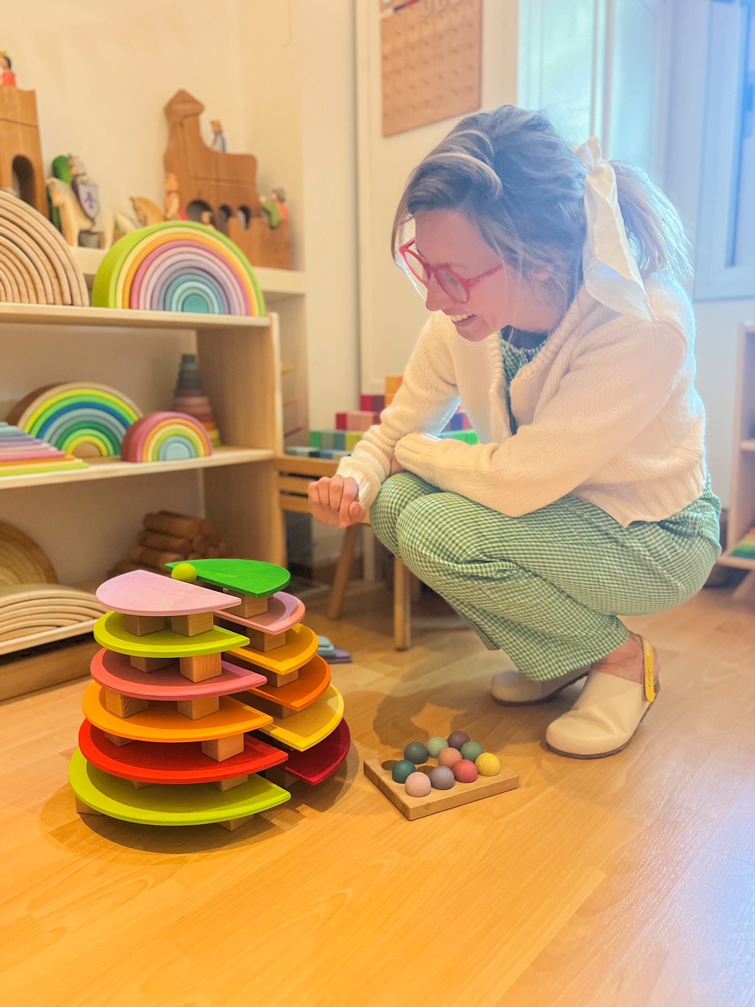 Woman playing with a wooden ballrun